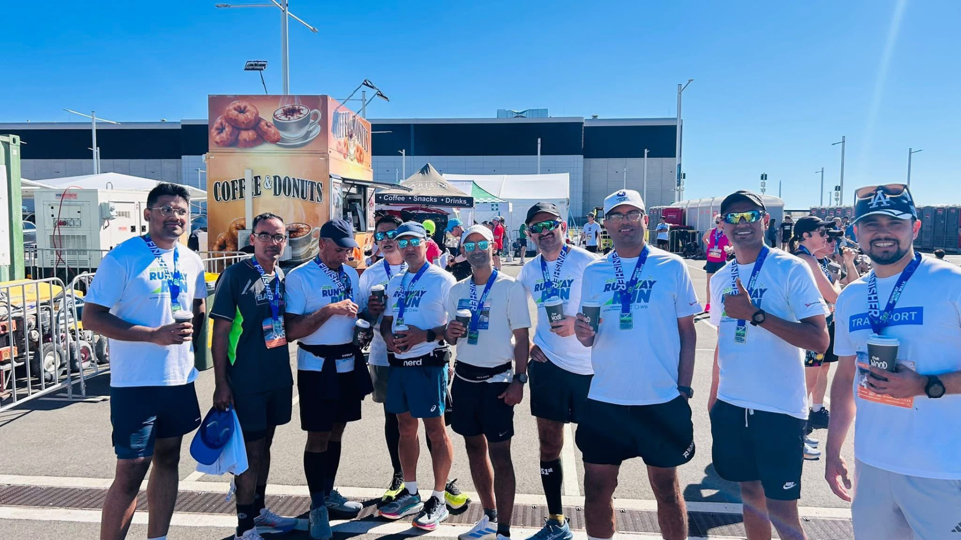 NRA runners with finisher medals enjoying coffee after the Runaway Run